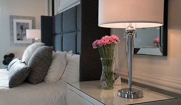 Penthouse master bedroom flowers on side table small